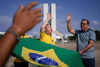 Evangelical pastors, supporters of Brazil's President Jair Bolsonaro, pray in front of National Congress, in Brasilia