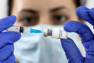 FILE PHOTO: Illustration shows a woman holding a mock-up vial labeled 