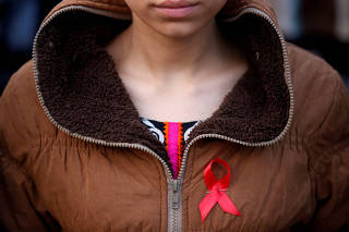 FILE PHOTO: A participant with a red ribbon pin takes part in HIV/AIDS awareness campaign ahead of World Aids Day, in Kathmandu