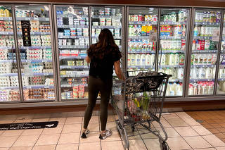 FILE PHOTO: A woman shops in a supermarket as rising inflation affects consumer prices in Los Angeles