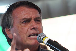 Brazil's President and candidate for re-election Jair Bolsonaro attends a news conference during a campaign rally in Recife