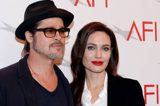 FILE PHOTO: Actor Brad Pitt and actress/director Angelina Jolie pose at the AFI Awards 2014 honoring excellence in film and television in Beverly Hills