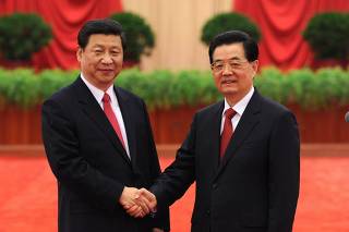 China's Hu and Xi shake hands at the 18th National Congress of the CPC at the Great Hall of the People in Beijing