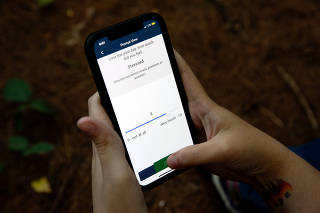 Katelin Cruz displays a survey question within an app on her smartphone in Ware, Mass., on Sept. 2, 2022. (Kayana Szymczak/The New York Times)