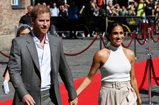 FILE PHOTO: Britain's Prince Harry and his wife Meghan in Dusseldorf