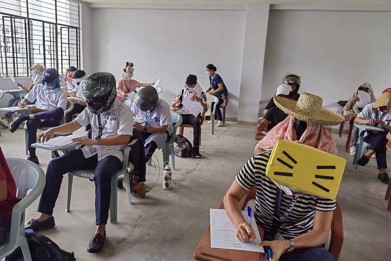 Com caixas de ovos e máscaras de papel, estudantes filipinos improvisam chapéus anti-cola