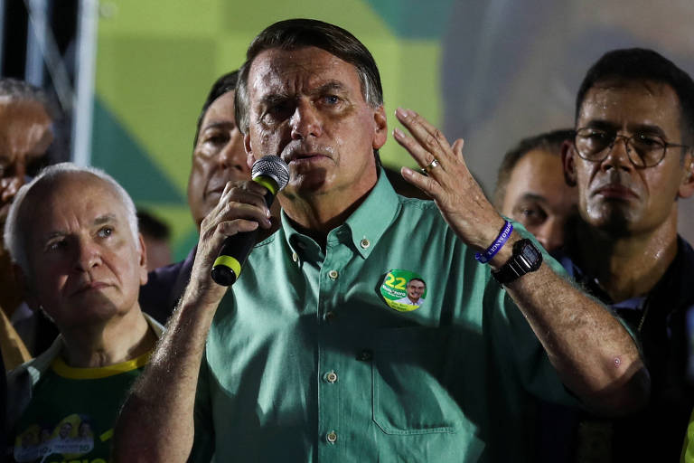 Bolsonaro gesticulando com o microfone e cercado por apoiadores