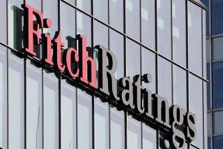 FILE PHOTO: The Fitch Ratings logo is seen at their offices at Canary Wharf financial district in London