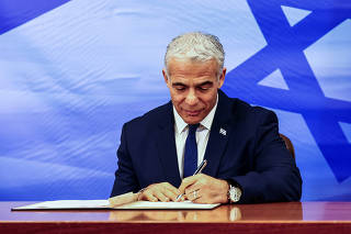 Israeli Prime Minister Yair Lapid signs U.S.-brokered deal setting a maritime border between Israel and Lebanon, at the Prime Minister's office in Jerusalem