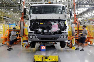 FILE PHOTO: Employees work on the new assembly line to build trucks at Mercedes Benz's trucks and buses manufacturing plant in Sao Bernardo do Campo