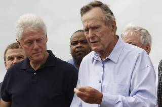 Former U.S. Presidents Bush and Clinton speak after the pair looked at damage from Hurricane Ike on the beach in Galveston