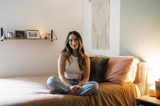 Lindsey Tindage, in her bedroom at the furnished Brooklyn apartment she has shared with others for 18 months, on Oct. 5, 2022. (Desiree Rios/The New York Times)
