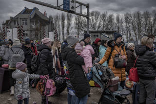 Refugees fleeing the Russian invasion of Ukraine gather at the border in Palanca, Moldova, March 6, 2022. (Laetitia Vancon/The New York Times)