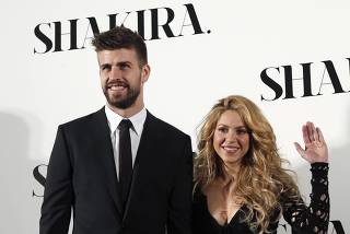 Colombian singer Shakira and Barcelona's soccer player Gerard Pique pose during a photocall presenting her new album 