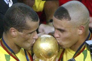 File photo shows Brazil's Ronaldo and Rivaldo kissing the World Cup trophy after their victory in Yokohama