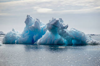 FILE PHOTO: An iceberg floats in a fjord near Tasiilaq, Greenland