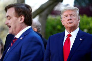 FILE PHOTO: My Pillow CEO Michael Lindell speaks as President Trump listens during the daily coronavirus (COVID-19) response briefing at the White House