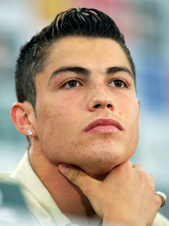 Close do rosto de Cristiano Ronaldo, em foto de 2004; ele olha para a frente e está com a mão direita no pescoço
