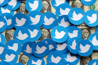 FILE PHOTO: Illustration shows Twitter logos and U.S. dollar banknotes