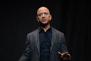 FILE PHOTO: Amazon founder Jeff Bezos speaks during an event about Blue Origin's space exploration plans in Washington