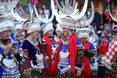 Women of the Miao ethnic minority, dressed in traditional costumes take part in the celebration of the Kuzang festival in Leishan county, in China's southwestern Guizhou province on November 11, 2022. (Photo by AFP) / China OUT