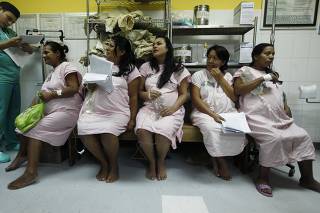 Mothers wait to be admitted to give birth inside the childbirth unit at hospital Escuela in Tegucigalpa