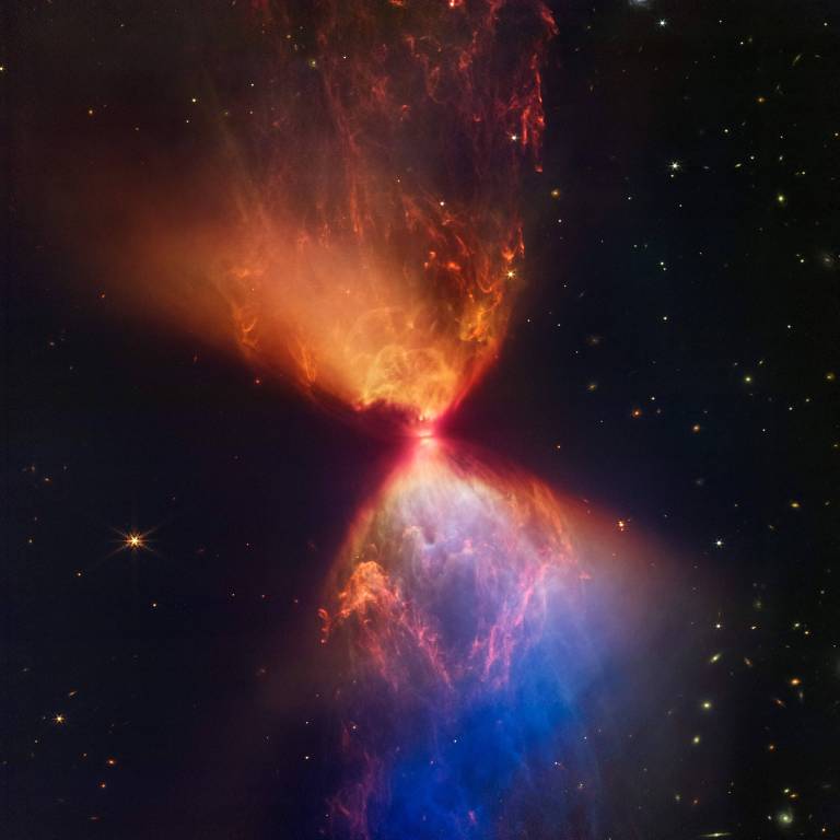 Imagem captada pela câmera infravermelha do Telescópio Espacial James Webb mostra a nuvem em formato de ampulheta em volta de uma jovem estrela