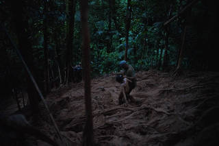 Sarah, 6, is guided through the Darién Gap in Panama by a friend, Luis José Martínez, on Oct. 6, 2022 after her mother, Dayry Alexandra Cuauro, developed debilitating blisters on her feet and fell behind their group of migrants. (Federico Rios Escobar/