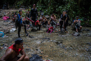 Migrants walk across the Darien Gap from Colombia into Panama, on Oct. 6 2022. (Federico Rios Escobar/The New York Times)