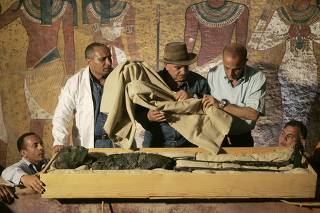 Zahi Hawass, head of the High Council for Antiquities, supervises the removal of the mummy of King Tutankhamen from his stone sarcophagus in his underground tomb in the Valley of the Kings in Luxor