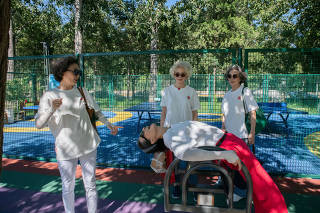Four members of Glamma Beijing at a park in Beijing, on Aug. 25, 2022. (Gilles Sabrié/The New York Times)
