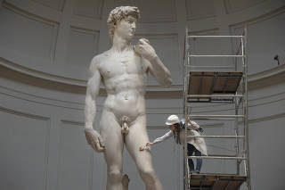 Restorer Eleonora Pucci at work in the Galleria dell?Accademia in Florence, Italy, on Nov. 21, 2022. (Chiara Negrello/The New York Times)