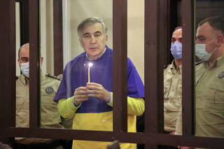 FILE PHOTO: Georgian former President Saakashvili prays for Ukraine during a court hearing in Tbilisi