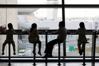FILE PHOTO: Children wait at the Ben Gurion International Airport near Tel Aviv