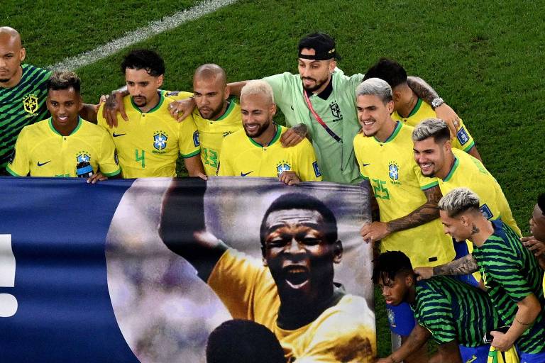 Jogadores posam com uma faixa com a foto de Pelé
