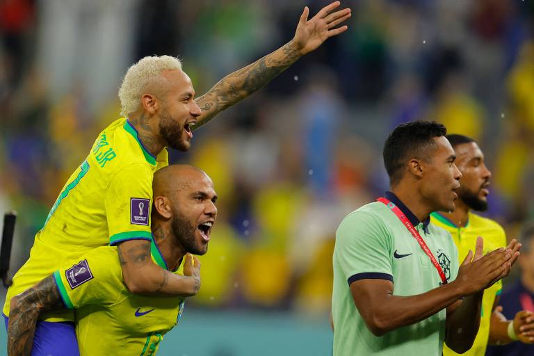 Daniel Alves carrega Neymar durante comemoração da vitória sobre a Coreia do Sul, na tarde desta segunda-feira (5)