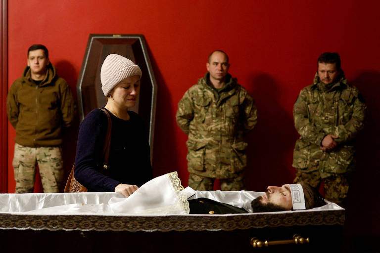 Amigos e familiares durante funeral em Kiev de militar ucraniano morto em combate contra tropas russas