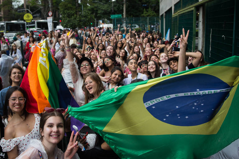 Fãs com bandeira do Brasil na fila na Av. Matarzzo, próximo ao Allianz Parque para o show do Harry Styles