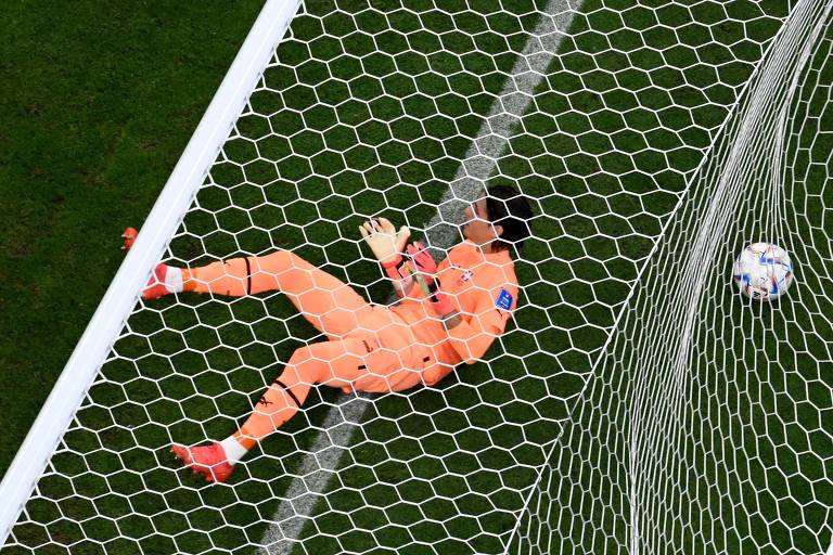 Bola na rede do suíço Sommer, que está caído sobre a linha do gol; o goleiro levou seis gols na derrota para Portugal por 6 a 1 no estádio de Lusail, no Qatar