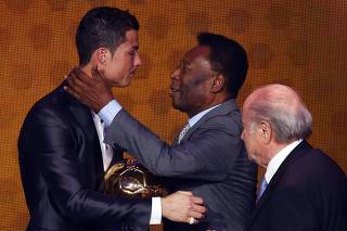 Portugal's Cristiano Ronaldo is congratulated by Pele as FIFA President Sepp Blatter looks on after being awarded the FIFA Ballon d'Or 2013 in Zurich
