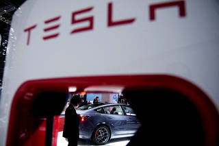 FILE PHOTO: A Tesla electric vehicle at the Auto Shanghai show in Shanghai, China