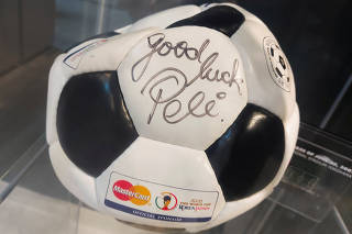 A promotional football for the 2002 World Cup signed by Brazilian legend Pele is seen at an exhibition of memorabilia in Doha