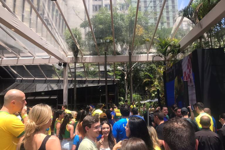 Homens e mulheres assistem ao jogo Brasil e Croácia em evento no hotel Tivoli Mofarrej, em São Paulo