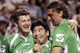 Diego Maradona celebrates after scoring with Davor Suker and Goran Ivanisevic during a charity soccer match in the Croatian Adriatic town of Novi Vinodolski