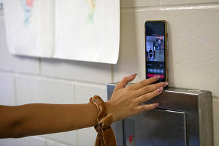 Kate Sandoval, 17, sets up her iPhone to record a TikTok at West Orange High School in Winter Garden, Fla. on Oct. 14, 2019. (Charlotte Kesl/The New York Times)