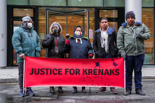 Members of the Krenak indigenous people demonstrate outside the High Court in London