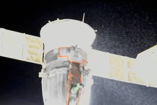 A stream of particles, which NASA says appears to be liquid and possibly coolant, sprays out of the Soyuz spacecraft on the International Space Station
