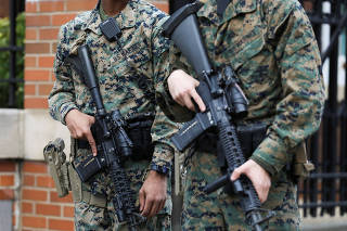 Members of the U.S. Marines stand guard outside of Barracks Row, a military housing unit in Washington