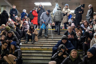 People take shelter inside the metro station during Russian missile attacks in Kyiv