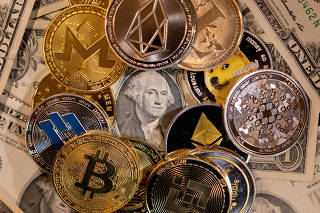 FILE PHOTO: Illustration shows representations of virtual cryptocurrencies on U.S. dollar banknotes